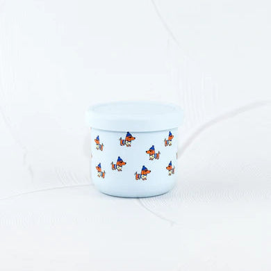 Small white container with blue lid featuring dog illustrations on a white background