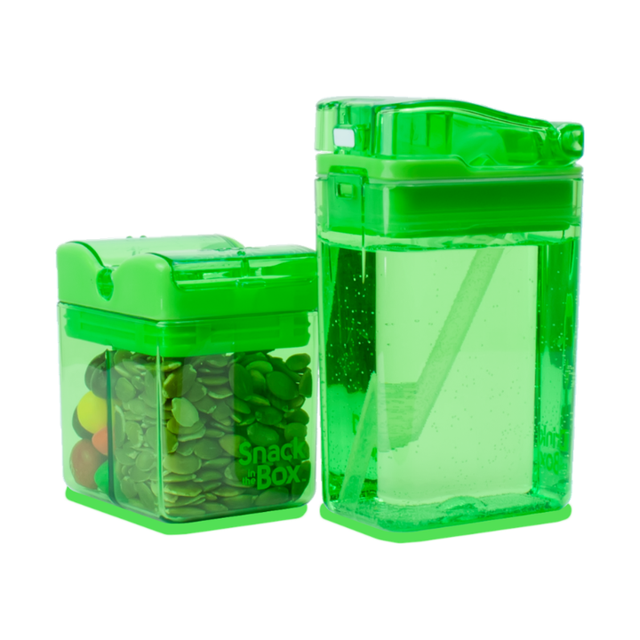 Two green transparent snack containers with snacks inside on a white background