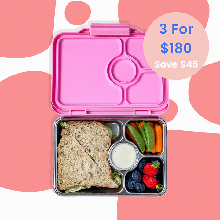 Pink bento box with a sandwich and vegetables on a pink background with promotional text.